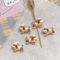 Detailed view of five cute resin puppy figurines with caps for DIY jewelry making - Yellow Nightcap Puppy