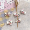Detail of five cute cartoon Dalmatian dog beads with pink hats for DIY bracelet making - White Nightcap Puppy