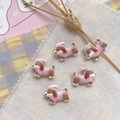 Close-up of cute resin dog charms with striped hats for DIY jewelry making - Pink Nightcap Puppy