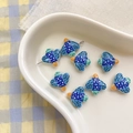 Close-up of bird-shaped ceramic beads with blue polka dots for DIY jewelry making - 15# Bird-Blue Green