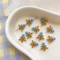 Macro detail of Christmas tree shaped alloy beads with blue and yellow striped enamel - 7# Tree-Blue Yellow