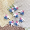Macro shot of colorful ceramic elephant beads for DIY jewelry making with polka dot details - Blue White Elephant