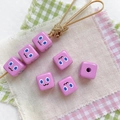 Macro detail of pink square DIY beads with cartoon facial expressions and pre-drilled holes - Purple-Square