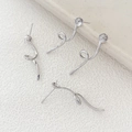 Macro shot of silver spiral geometric ribbon earring findings with pearl base settings - White Gold