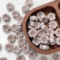 Close-up of vintage Czech glass flower beads with retro brown pattern and hole detail - 1 Piece / Vintage Brown