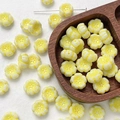 Macro view of flower-shaped Czech glass beads in creamy white with yellow edges for DIY - 1 Piece / Yellow White