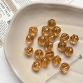 Macro detail of amber glass pumpkin beads with golden trim on a textured plate - 1 Piece / 2# Light Amber