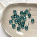 Macro shot of lake blue pumpkin beads with gold accents on a ceramic craft tray - 1 Piece / Lake Blue