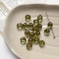 Detailed view of olive green pumpkin glass beads with vintage bronze enamel accents - 1 Piece / 13# Olive Green