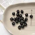 Close-up of vintage black pumpkin beads with gold accents for DIY jewelry making - 1 Piece / 15# Black Gold Traced