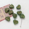 Macro shot of dark green heart glass beads with gold floral details and straight hole view - 13# Deep Teal