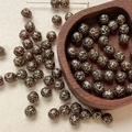 Detailed view of 8mm Czech glass beads with vintage gold rose pattern for DIY jewelry - Dark Red Gold Scroll (16#)