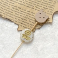 Macro shot of retro etched glass bead with gold sunflower motif on a wooden hair stick - Creamy White Gold Sunflower With Wood Bear Head (Style 4)