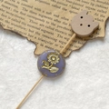 Detailed macro of vintage purple etched Czech bead with gold floral pattern for DIY jewelry - Purple Gold Sunflower With Wood Bear Head (Style 5)