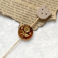 Macro detail of amber Czech glass bead with gold sunflower engraving for DIY jewelry - Amber Gold Sunflower With Wood Cat Head (Style 9)