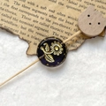 Macro detail of a vintage purple glass bead with gold floral relief and celestial pattern - Dark Purple Gold Sunflower With Wood Bear Head (Style 10)