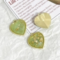 Detailed close-up of light green heart pendants with gold leaf foil and beaded edges - Light Green Gold Foil Style