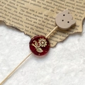 Detailed view of a vintage dark red bead with golden sunflower engraving and a wooden bear charm - Dark Red Gold Sunflower With Wood Bear Head (Style 12)