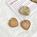 Detail of heart-shaped DIY charms with gold leaf inlay and textured golden finish - Pink Orange Gold Foil Style