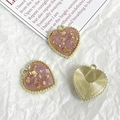 Macro detail of heart charm with pink gold foil inlay and gold textured back - Pink Gold Foil Style