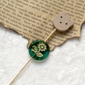 Macro detail of vintage green floral glass bead and wooden bear craft pick accessory - Emerald Green Gold Sunflower With Wood Bear Head (Style 13)
