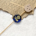 Macro shot of retro dark blue Czech bead with gold sunflower pattern and wood bear charm - Dark Blue Gold Sunflower With Wood Bear Head (Style 14)