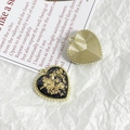 Detail of heart-shaped gold alloy pendants with gold foil and ribbed textures for DIY jewelry - Black Blue Glitter Style