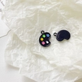 Detailed macro view of black enamel artist palette charms with colorful paint droplets - Black Palette