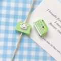 Macro detail of cute green hand-painted toast-shaped beads for DIY jewelry making - Toaster Style / Blue Toaster
