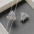 Macro shot of silver carriage charm with a purple heart zircon and micro-pave crown detail - Silver Purple Zircon Carriage