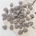 Macro view of gold-trimmed purple leaf glass beads showing intricate vein details - 5-Pack / Light Purple