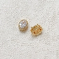 Detailed macro view of 18k gold-plated oval zircon beads showing stone setting and back - White (18K Gold Plated)