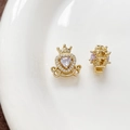 Macro view of 18k gold plated heart carriage charms with purple and white zircon stones - Purple