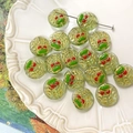 Detailed view of handmade green cherry glass beads with gold foil and red accents in a tray - Light Green Translucent Face Style (#3) / 1 Piece