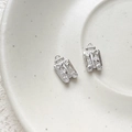 Macro shot of silver mini suitcase charms with heart pattern and tiny zircon wheels - Platinum Color Suitcase