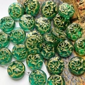 Macro detail of green glass beads with gold floral carving for DIY jewelry making - 1 Piece Pack / Dark Green