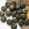 Macro view of vintage black round beads with detailed gold peony floral relief carvings - 1 Piece Pack / Black