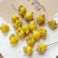 Macro detail of yellow spiral glass beads with gold accents for DIY jewelry making - Yellow