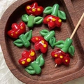 Detail of handmade lampwork tulip glass beads in red and green for DIY jewelry making - 1 Piece / Red
