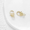Macro detail of gold-plated heart lobster clasps with intricate hollow flower patterns - Relief Pattern Style / 2# 18K Gold Style