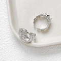 Macro shot of hollow textured 14k gold plated ring base with silver finish and zircon - White Gold