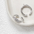 Detail of silver plated open ring with lava texture and small rhinestones on ceramic tray - 6# White Gold