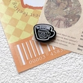 Detailed close-up of a black enamel coffee cup brooch with white floral illustration - 11# Black (Single)