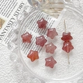 Star-shaped strawberry quartz beads for DIY jewelry making displayed on a glass plate - Rose Quartz