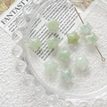 Macro detail of star-shaped light green natural stone beads with smooth marble textures - Light Green