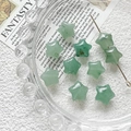 Macro detail of star-shaped green natural stone beads for DIY jewelry making - Cyan