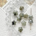 Macro view of star-shaped grey labradorite gemstone beads for DIY jewelry making - Army Green
