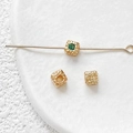 Macro detail of 18k gold plated cube beads with green zircon and hammered metal texture - 18K Gold Plated Green Zirconia