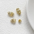 Macro shot of gold-plated lantern-shaped clasp with vertical stripes and zircon inlay - 18k Gold Lantern Connector