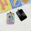 Macro view of The Lovers tarot enamel pendant showing bird design and textured back - The Lovers